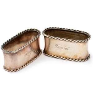 A pair of silver wedding napkin rings