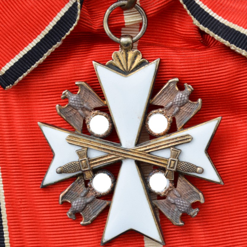 The badge of the order of merit of the German eagle 1 class with swords ribbon on the shoulder