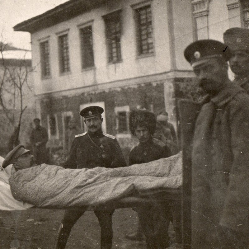 Photo of a group of officers RIA at the stretcher of a wounded colleague