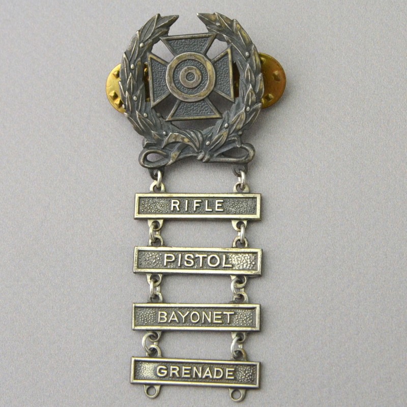 The badge of the expert shooter of the US Army with the bars "pistol", "bayonet", "grenade" and "rifle"