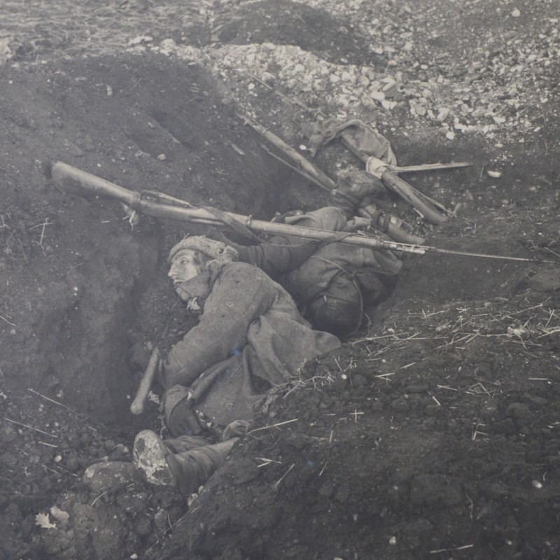 Large-format photo of the dead Russian soldiers in the trench