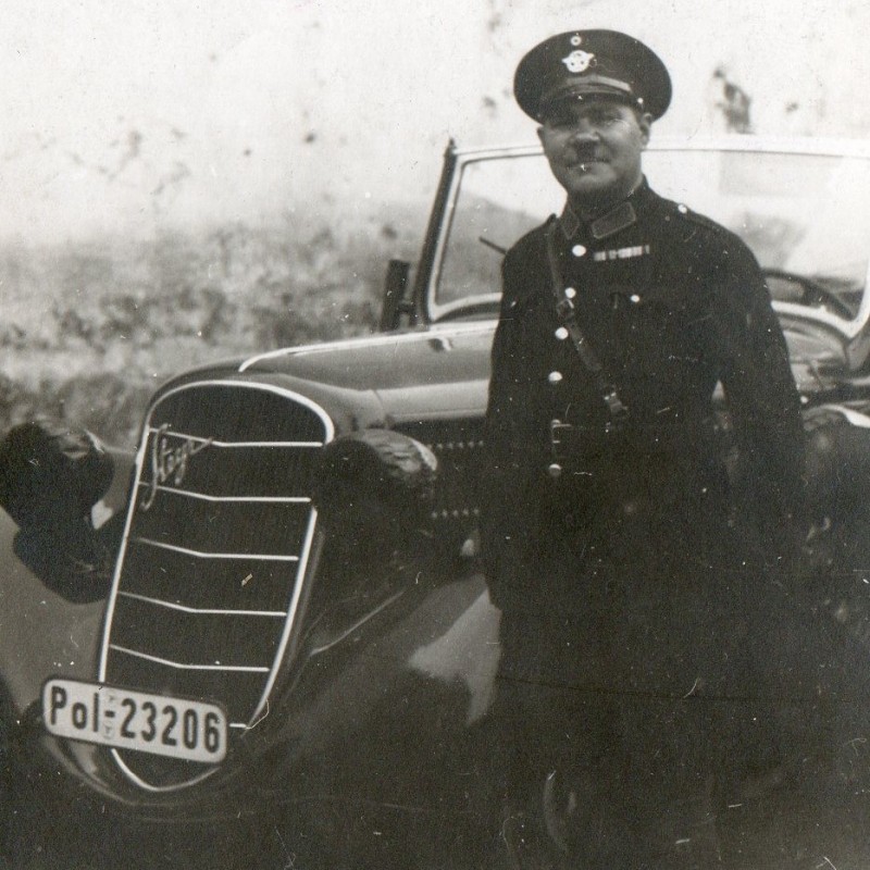 Photo of a German police officer with a police car of the brand "Steyr"