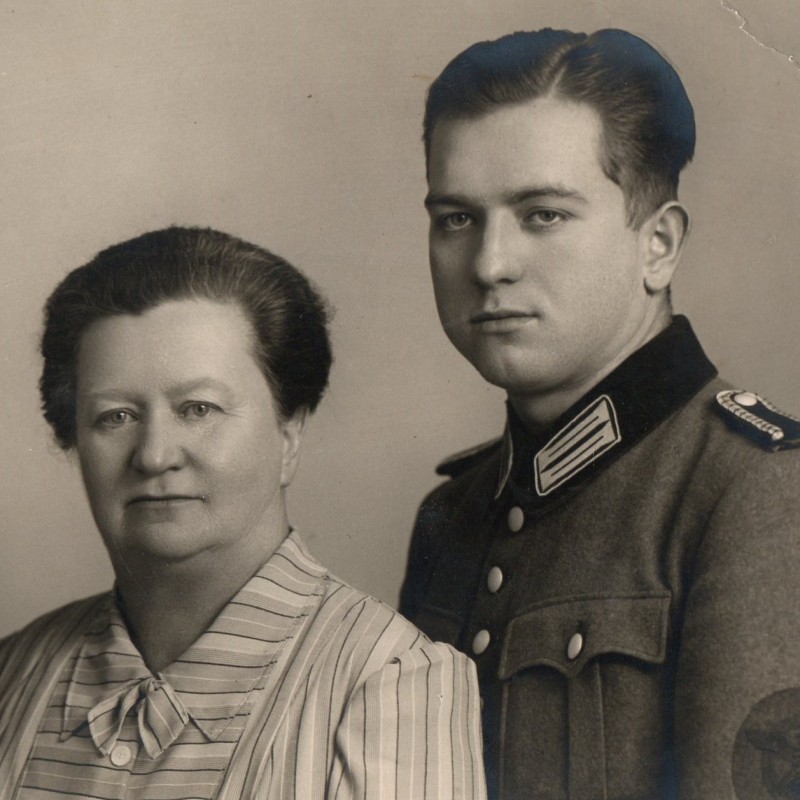 Large-format photo of a policeman-sergeant with his mother and sister