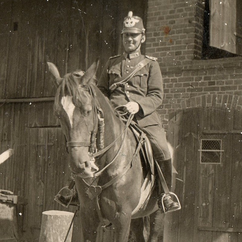Photo of a German policeman in shako on a horse