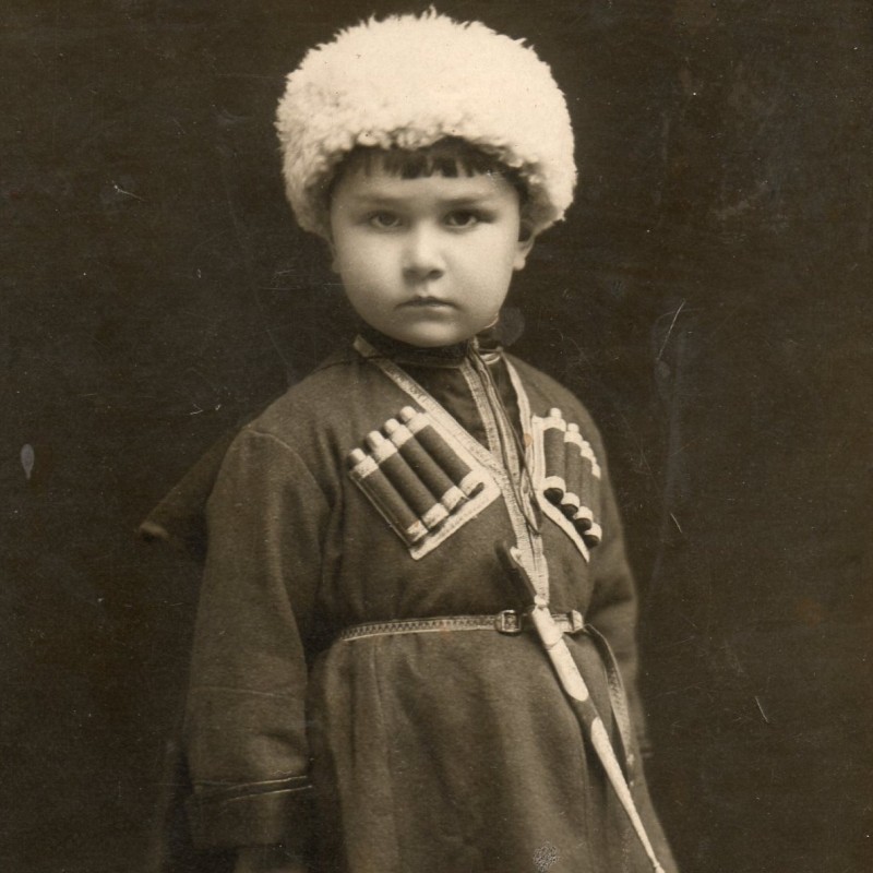 Photo of a boy in Caucasian national clothes with a dagger