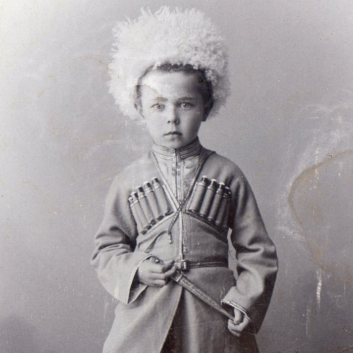 Photo of a boy in Caucasian national clothes with a dagger
