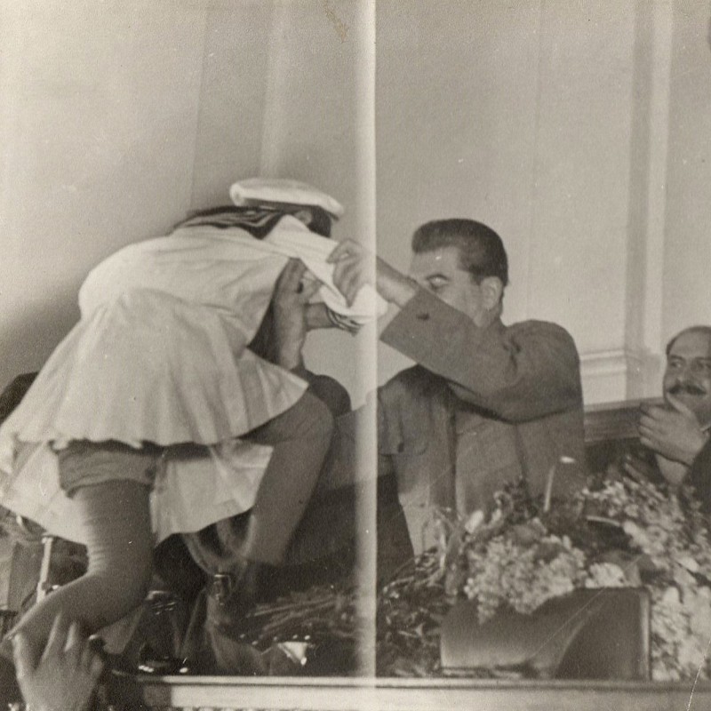 Photo "I.V. Stalin at a meeting of the wives of commanders and senior staff of the Red Army raises a pioneer to the presidium"