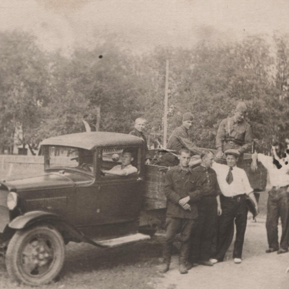 Photos of Red Army soldiers and civilians at a military truck of the Red Army