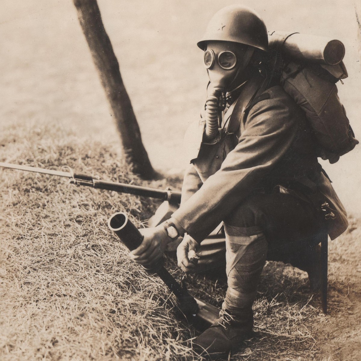 Photo of a Japanese soldier in a gas mask, with a rifle