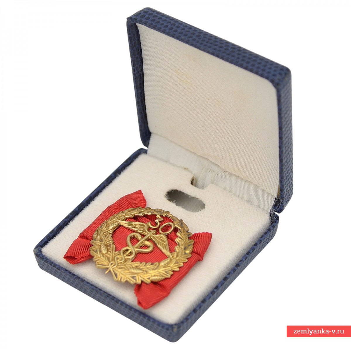A silver badge for 30 years of service in the Finnish customs, in a case