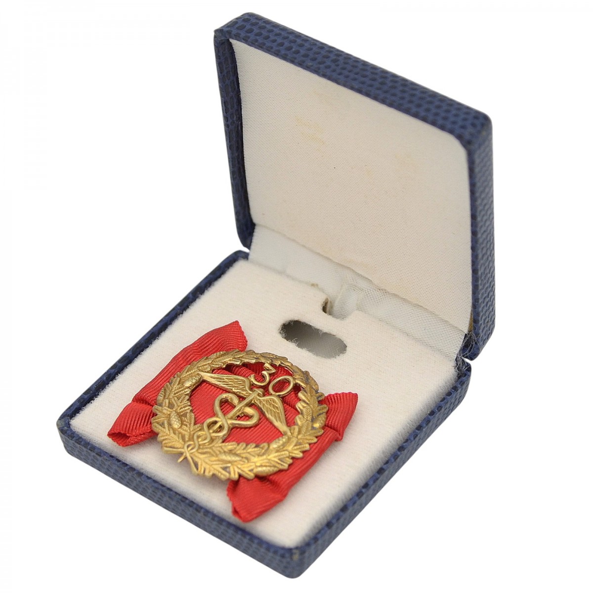 A silver badge for 30 years of service in the Finnish customs, in a case
