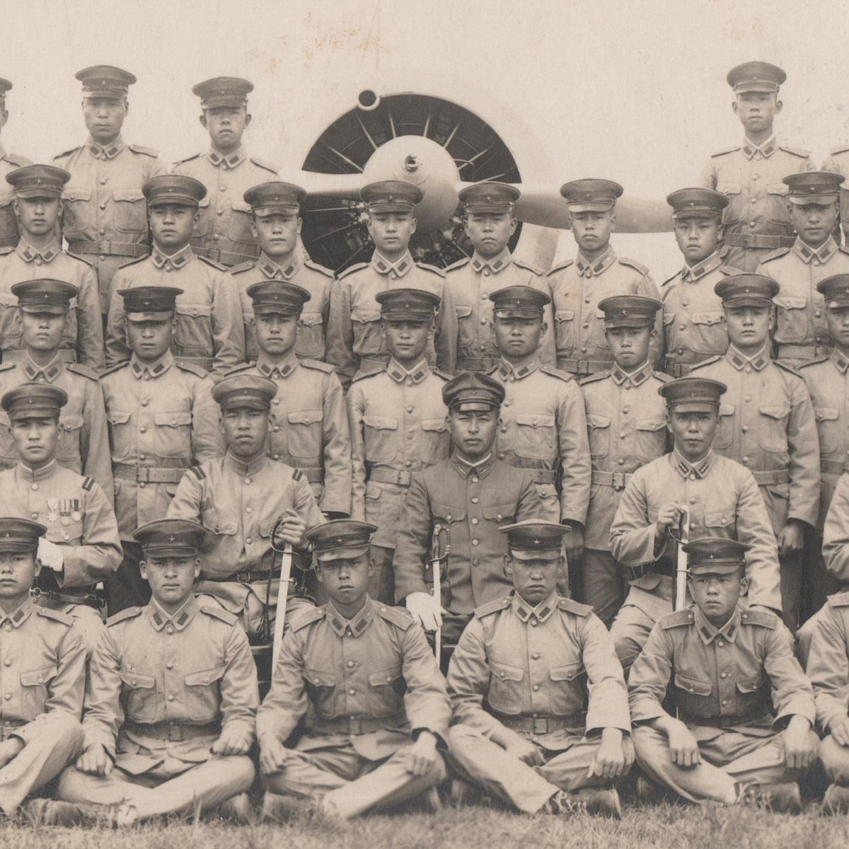 Photo of a Japanese army unit at a combat aircraft