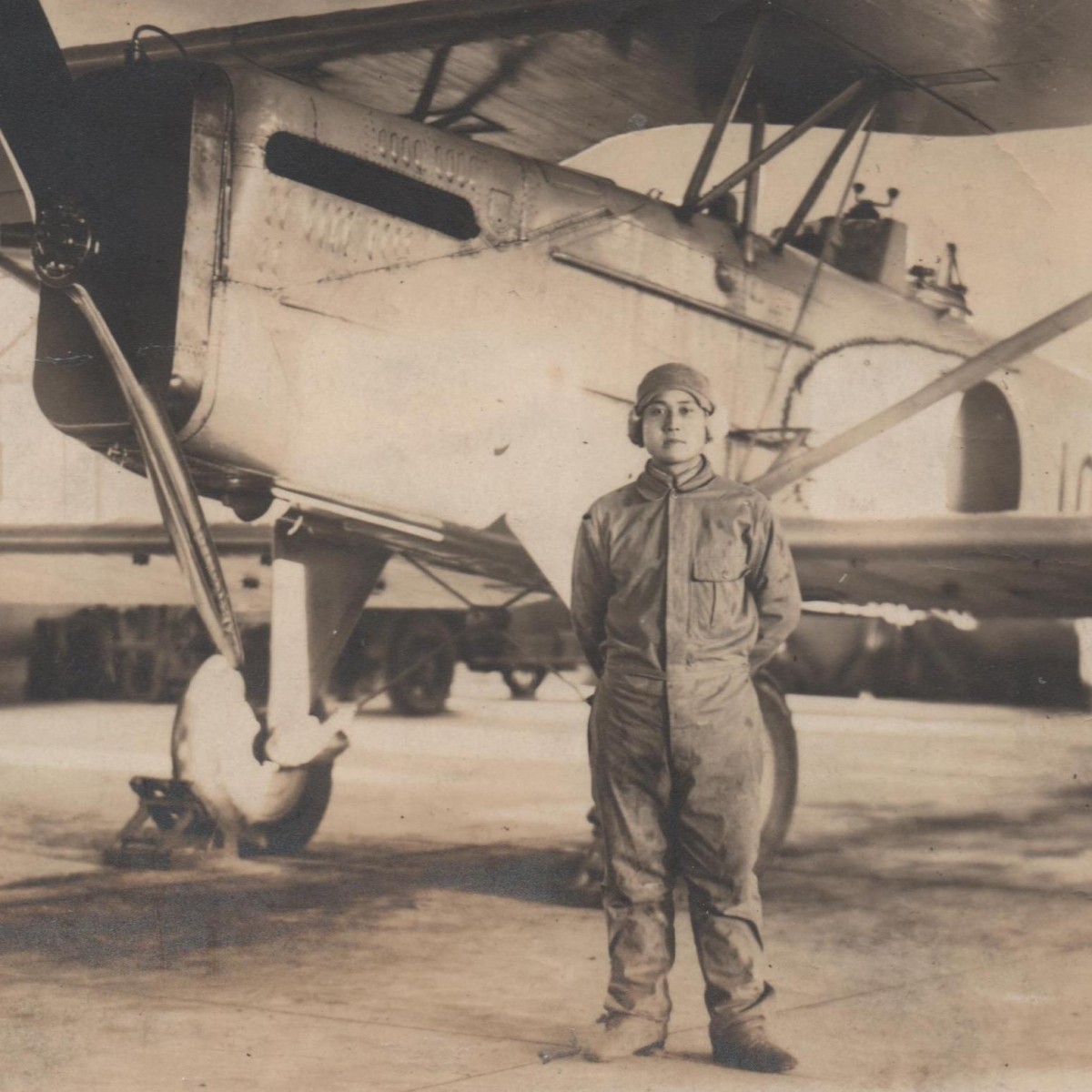 Photo of a Japanese pilot with a biplane