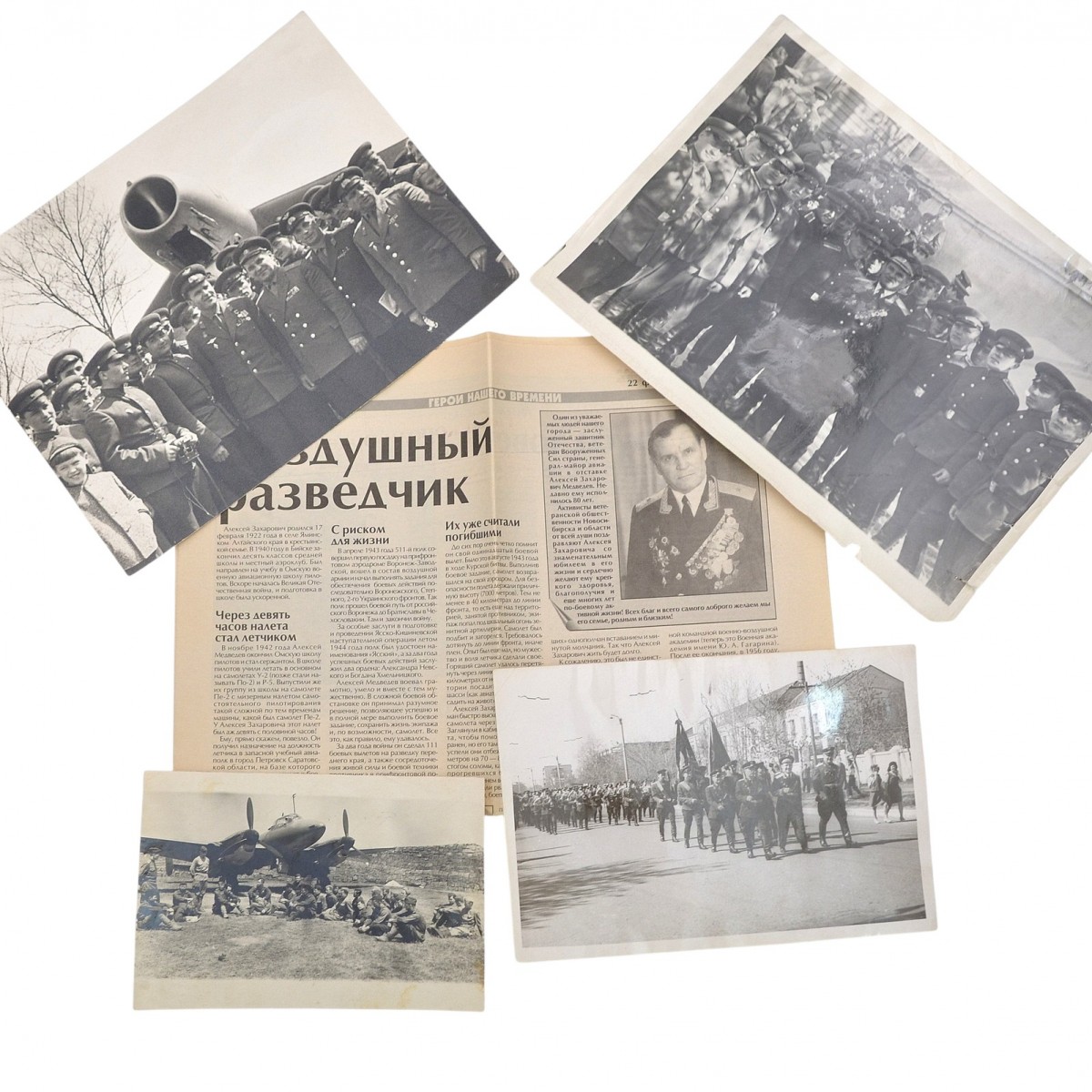 A lot of photos and a newspaper clipping with an article about Major General A.Z. Medvedev