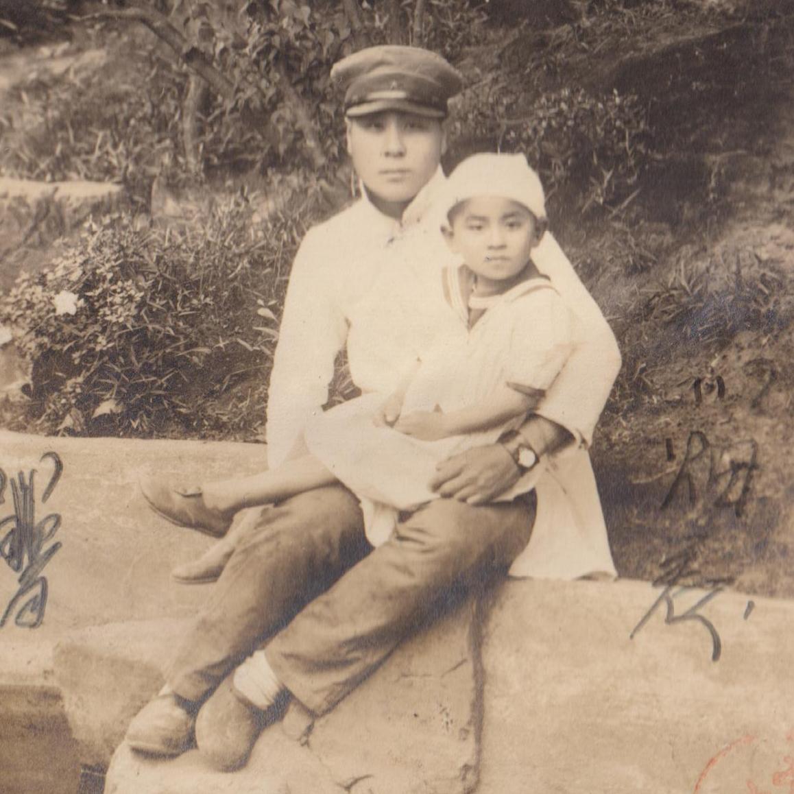 Portrait photo of a Japanese soldier with a child
