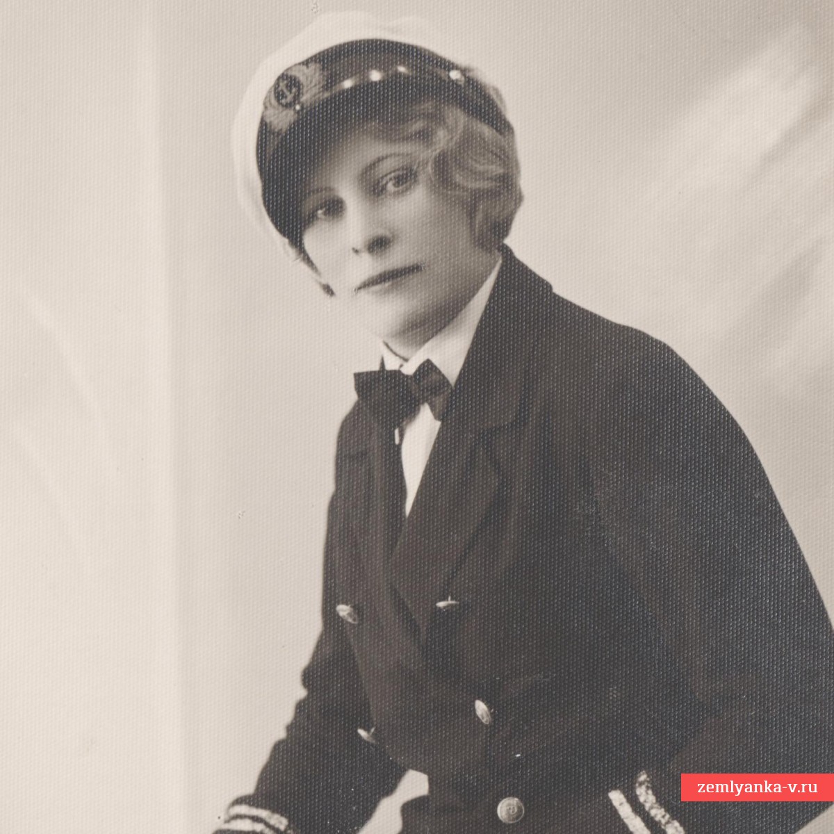 Photo of a girl in the uniform of a merchant marine captain, with a cutlass