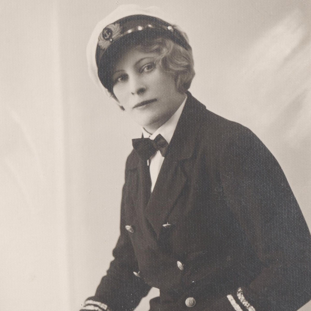 Photo of a girl in the uniform of a merchant marine captain, with a cutlass
