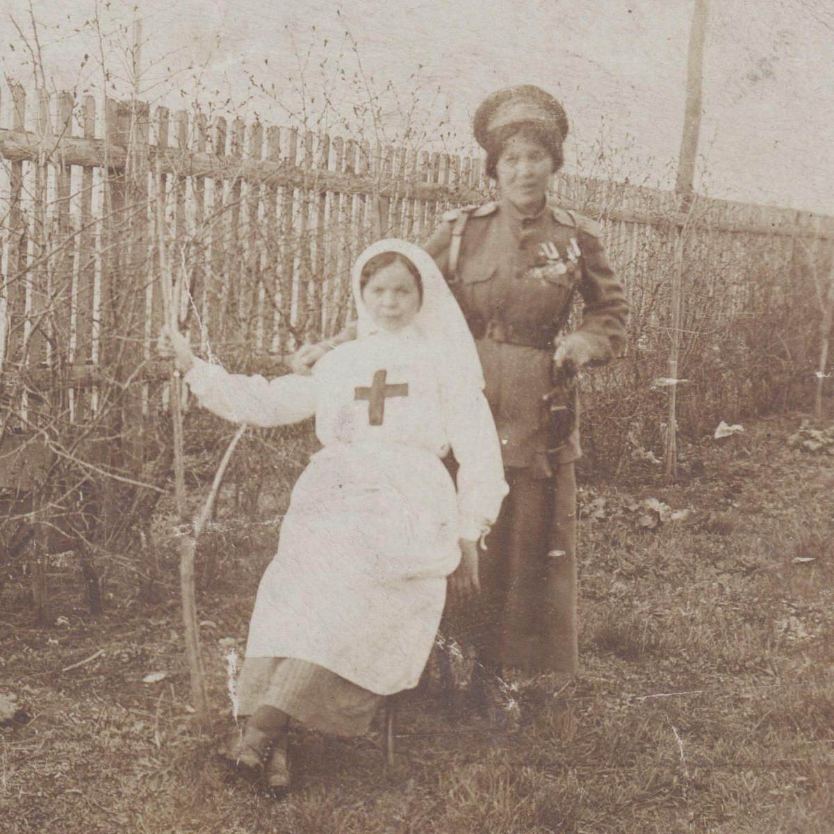 Photo of a sister of mercy and a woman in the uniform of an infantry regiment officer, with awards