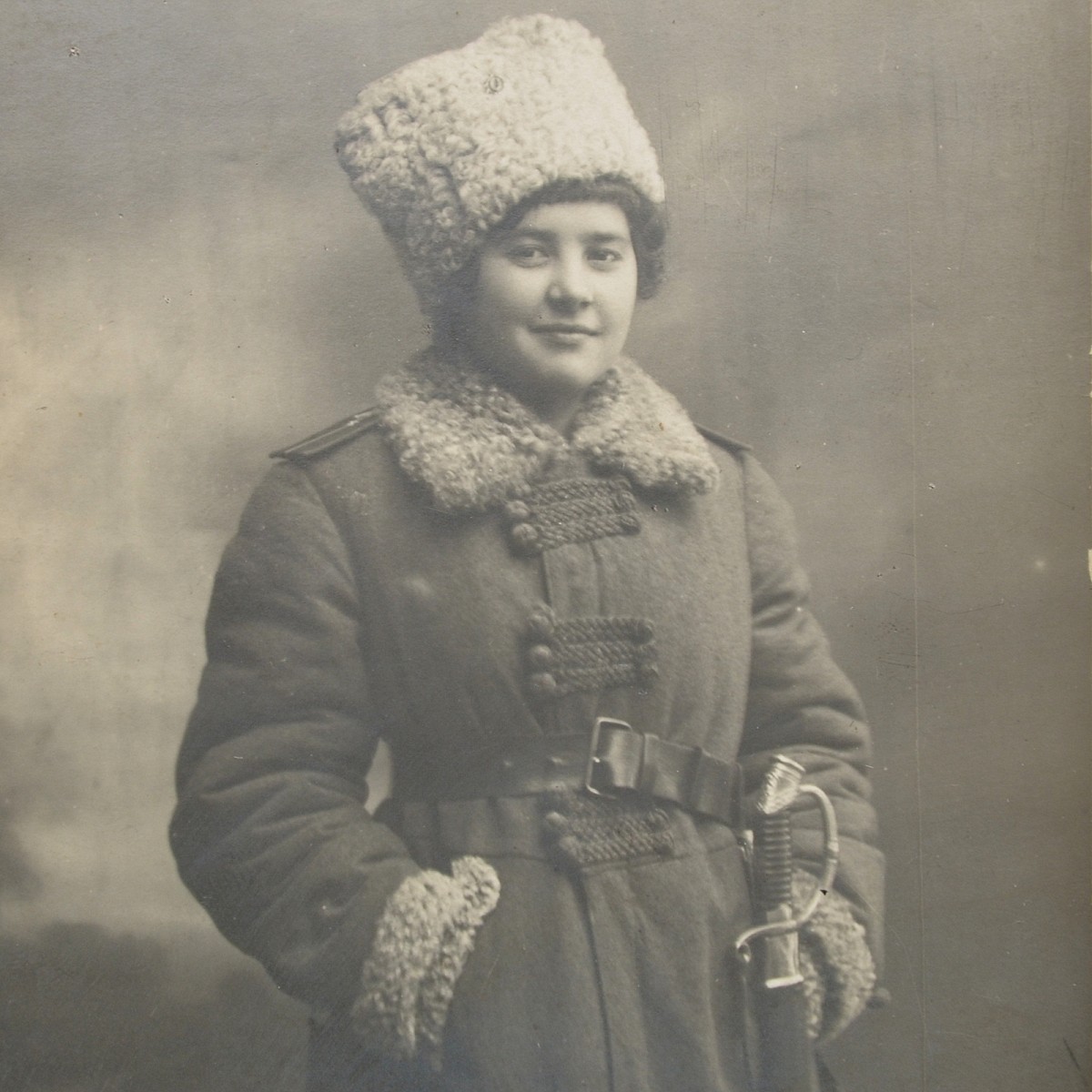 Photo of a girl in the uniform of a lieutenant of one of the RIA infantry regiments, with a sword