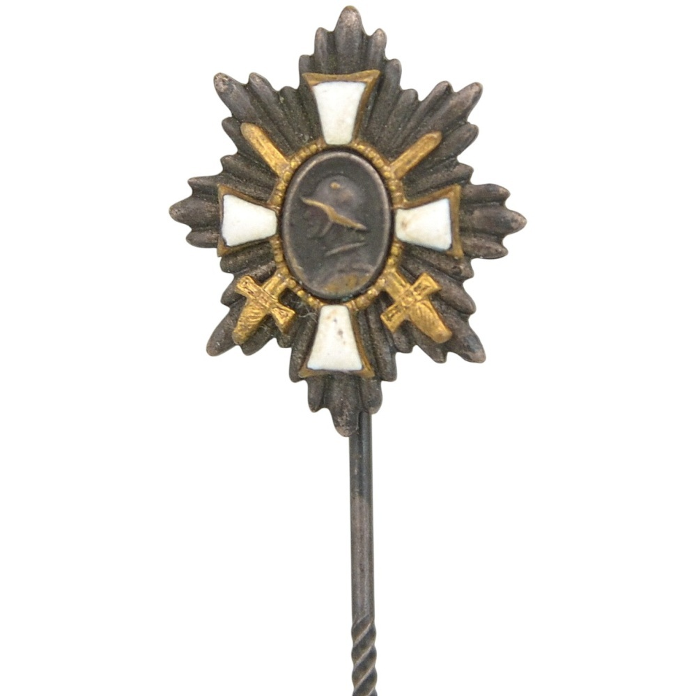 A miniature version of the "German field badge of Honor" on a needle